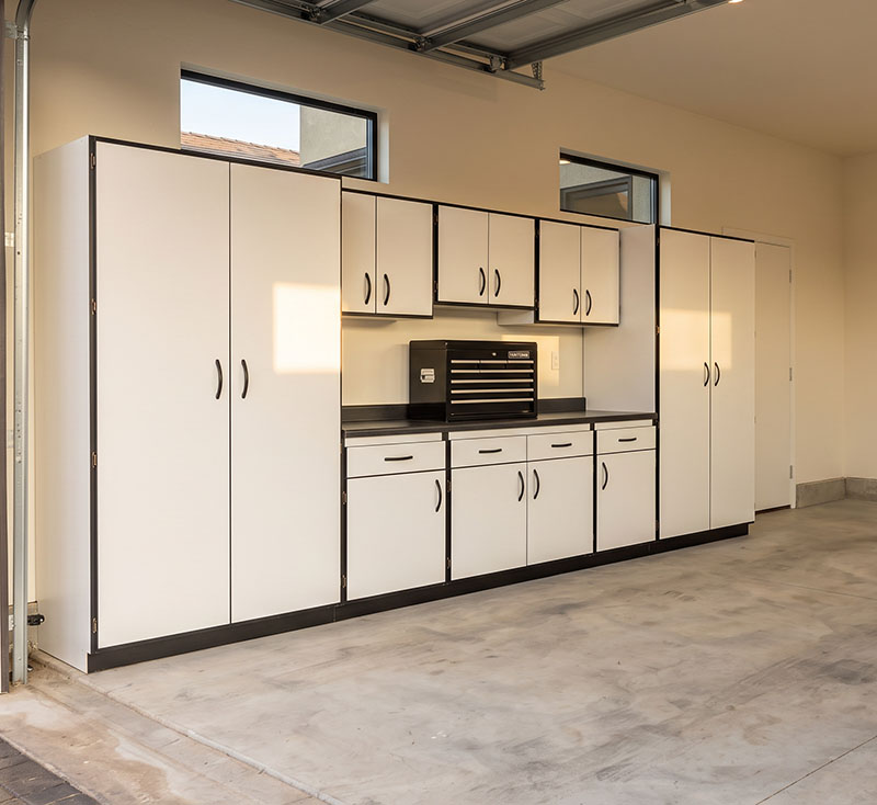 Custom white garage cabinets with workbench